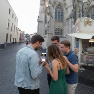 A group of young adults play a city game on a smartphone in front of the Grote Kerk in Breda.