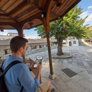 A man sits under a wooden fountain in the courtyard of the Gazi Husrev-beg Mosque in Sarajevo.