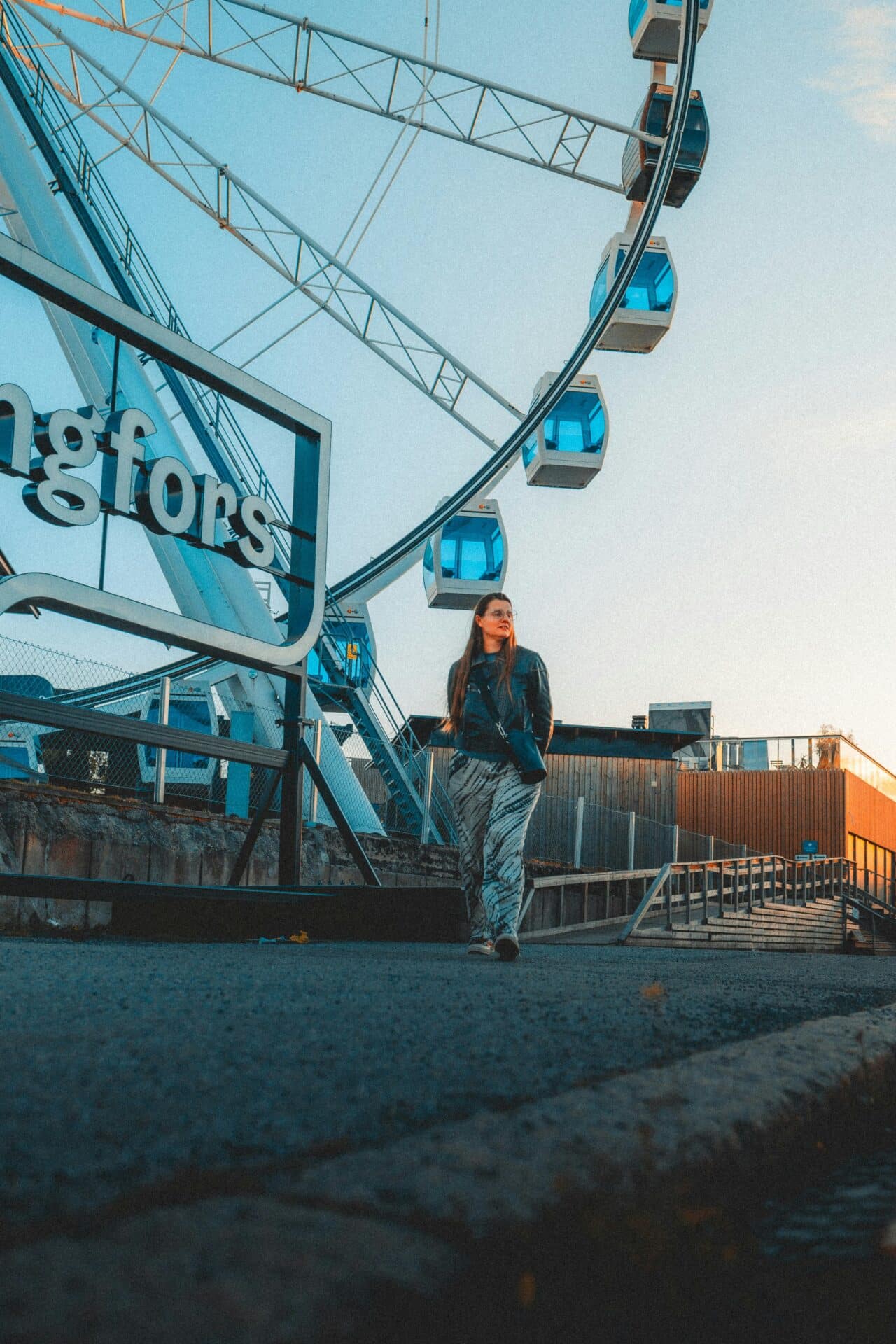 Woman Walking by the SkyWheel in Helsinki