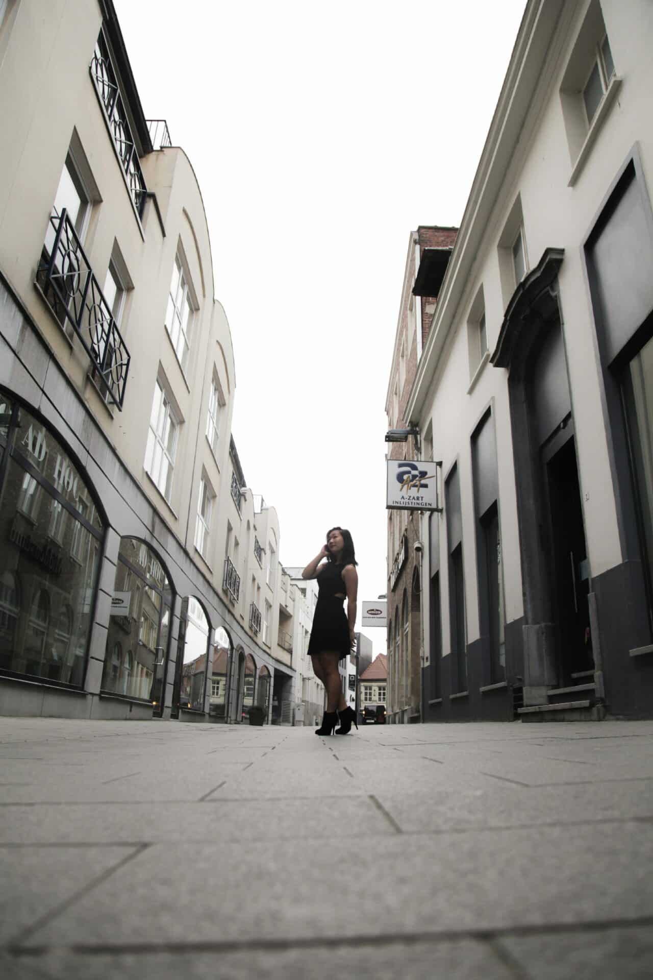 Woman Standing in a Narrow Street in Kortrijk
