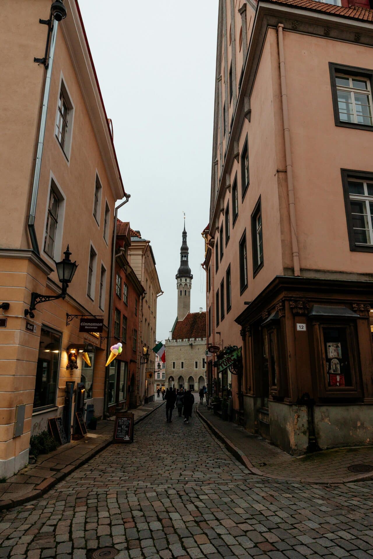 View of Tallinn Town Hall Spire From a Cobblestone Street
